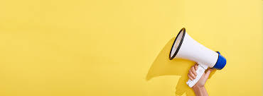imagem de uma mão segurando um megafone e um fundo amarelo